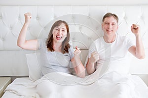 Happy smiling middle age couple in bed in t shirt. Healthy family relationships. Copy space