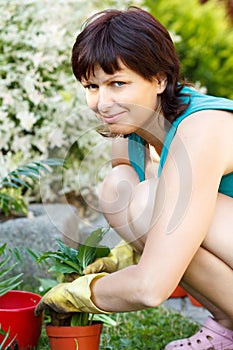 Happy smiling middle age woman gardening