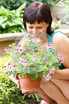 Happy smiling middle age woman gardening