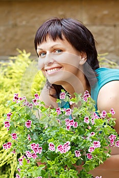 Happy smiling middle age woman gardening