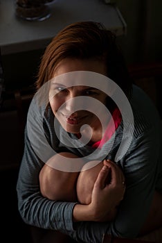 Happy smiling middle aged woman, forty years old. Ordinary woman without make-up at home