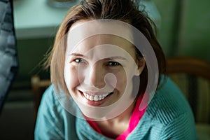 Happy smiling middle aged woman, forty years old. Ordinary woman without make-up at home.
