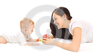 Happy smiling mother and baby playing in toys over white