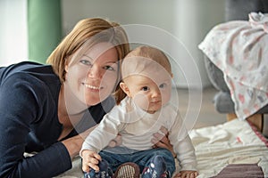 Happy smiling mother with cute baby child