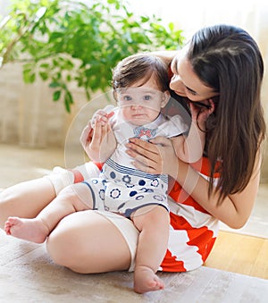 Happy smiling mother with eight month old baby