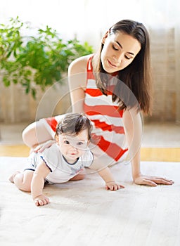 Happy smiling mother with eight month old baby girl