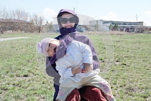 Happy smiling mother and little girl outdoor outside in early spring nature park. maternity and healthy lifestyle concept