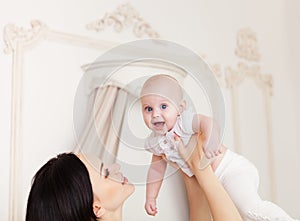 Happy smiling mother with six month old baby girl