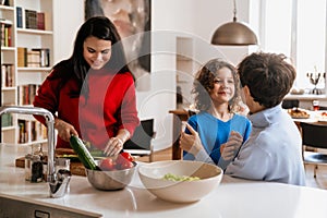 Happy multigenerational family cooking together in kitchen at home