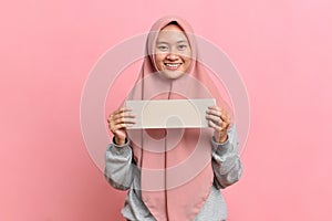 Happy smiling Muslim woman holding white board