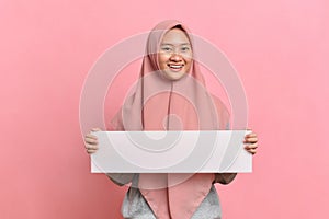 Happy smiling Muslim woman holding white board