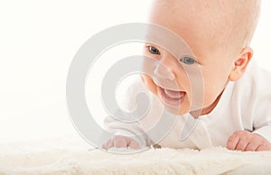Happy smiling newborn baby on white background
