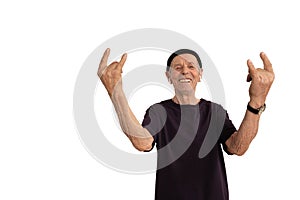 Happy smiling old man in black t-shirt and hat, senior doing rock and roll gesture, isolated over white background