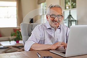 Happy smiling old man with laptop
