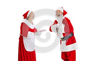 Happy smiling old man in Santa Claus costume and cute elder woman, missis Claus talking isolated on white background.