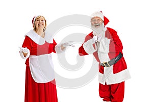 Happy smiling old man in Santa Claus costume and cute elder woman, missis Claus talking isolated on white background.