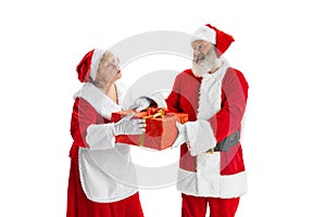 Happy smiling old man in Santa Claus costume and cute woman, missis Claus with gift boxes isolated on white background.