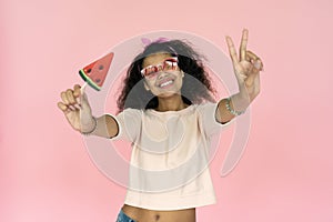 Happy smiling playful young african american teen girl black woman wear stylish glasses eyewear hold watermelon candy ice cream