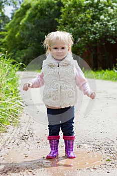 Happy smiling portrait of a 2 year old blonde girl