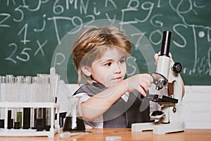 Happy smiling pupil drawing at the desk. schoolchild. It was a little chemistry experiment. Chemistry lesson. School