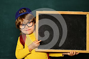Happy smiling pupils drawing at the desk. Cheerful smiling child at the blackboard. Classroom. September 1. Back to