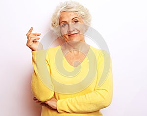 Happy smiling retired senior woman looking at camera isolated on white background