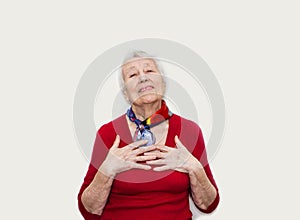 Happy smiling retired senior woman looking at camera isolated on white background photo