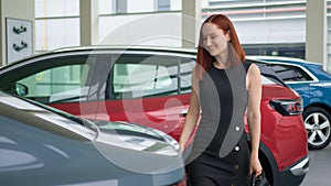 Happy smiling rich customer Caucasian woman smile client buyer female businesswoman girl touching car choosing new