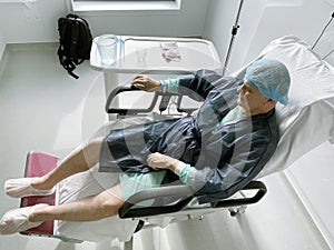 Happy smiling senior man - elevated view of lying on the medical chair senior