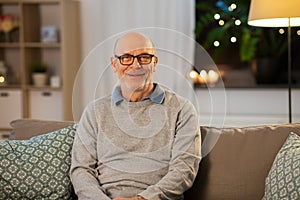 Happy smiling senior man in glasses at home