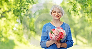 Happy smiling senior woman with flowers