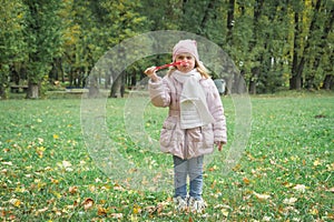 Happy smiling small five years old caucasian girl in warm clothes