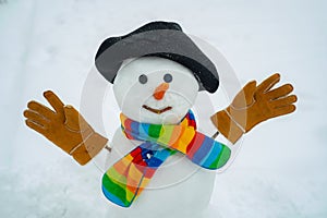 Happy smiling snow man on sunny winter day. Snowman. Happy snowman standing in winter Christmas landscape. Cute little