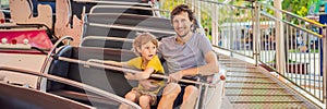 happy smiling son and his handsome father spending fun time together at amusement park BANNER, LONG FORMAT