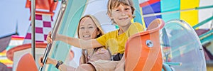 happy smiling son and his mother spending fun time together at amusement park BANNER, LONG FORMAT