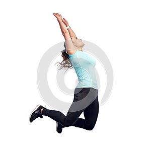 Happy smiling sporty young woman jumping in air
