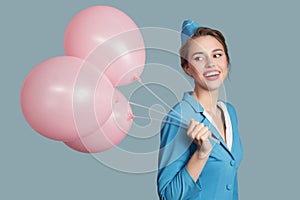 Happy smiling stewardess with pink balloons