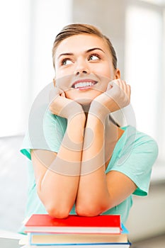 Happy smiling student girl with books