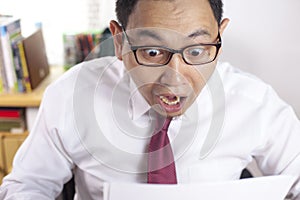 Happy Smiling Surprised Businessman Reading Positive Financial Report