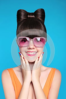 Happy smiling teen girl with bow hairstyle, funny model wearing