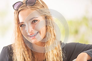 Happy smiling teen girl with dental braces