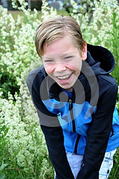 Happy smiling teenage boy with blond hair