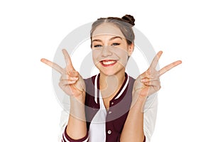 Happy smiling teenage girl showing peace sign