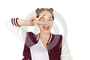 Happy smiling teenage girl showing peace sign