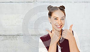 Happy smiling teenage girl showing thumbs up