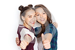 Happy smiling teenage girls showing thumbs up