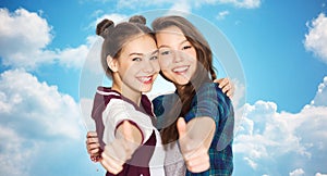 Happy smiling teenage girls showing thumbs up