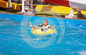 Happy smiling teenager boy in amusement park