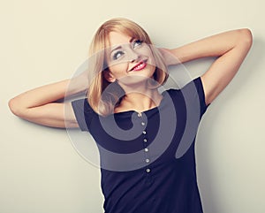 Happy smiling thinking young casual woman relaxing and looking u