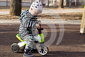 Happy smiling toddler boy riding bike. Kids enjoying a bicycle ride. Active toddler. Sport concept. Educational toys for